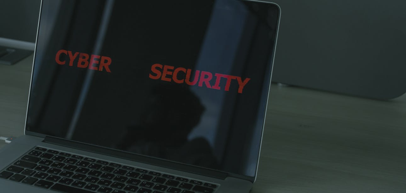 Close-up of a laptop displaying cybersecurity text, emphasizing digital security themes.