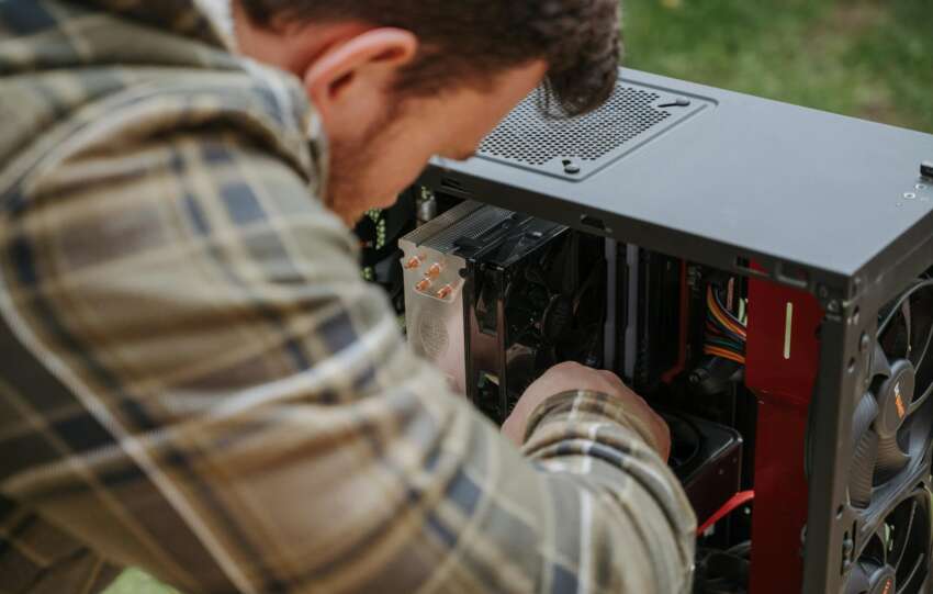 man performing diy computer maintenance outdoors