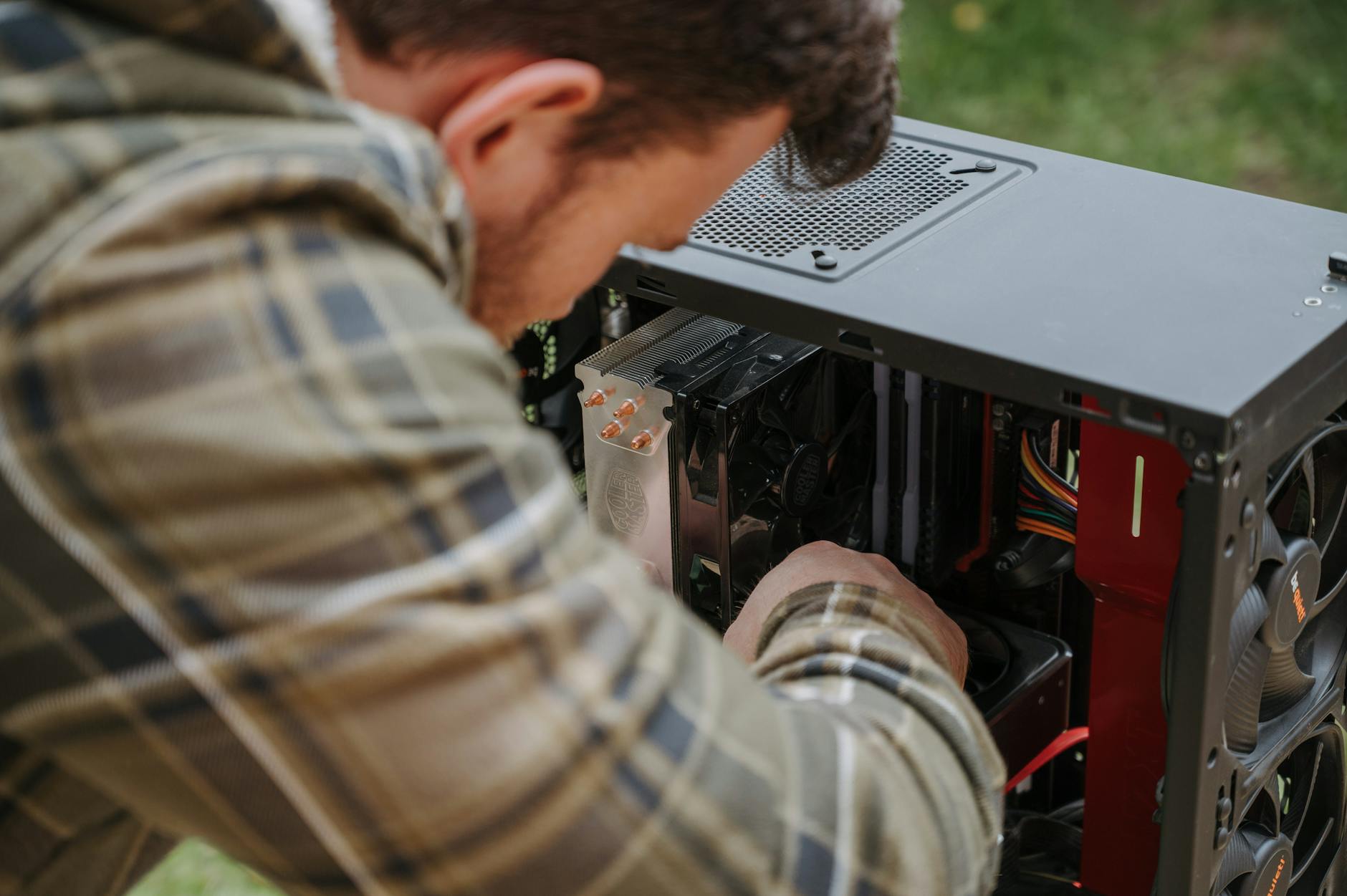 man performing diy computer maintenance outdoors