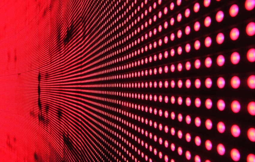 Vibrant abstract pattern of illuminated red LED lights forming a dynamic design.
