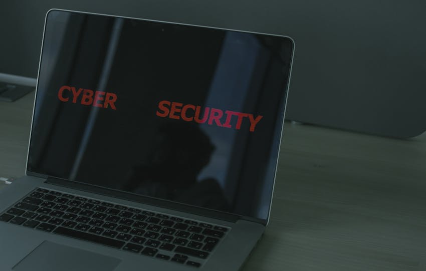 Close-up of a laptop displaying cybersecurity text, emphasizing digital security themes.