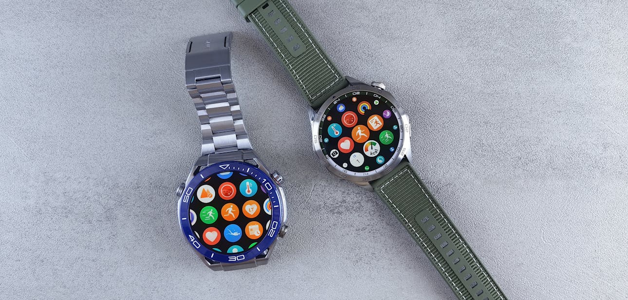 Close-up of two smartwatches on a gray background highlighting design and technology.