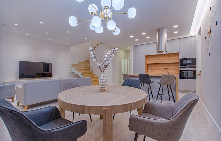 Stylish open-plan living room and kitchen with modern furnishings and lighting.