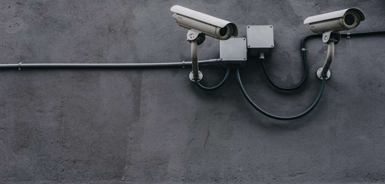 two gray bullet security cameras